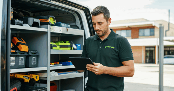 A tradesperson checking the stock management tool on his tablet